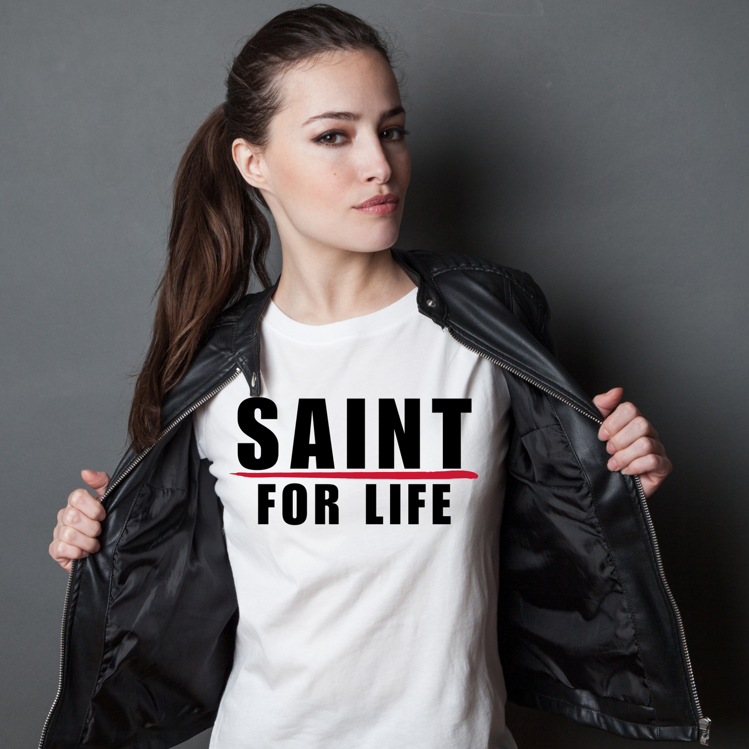 young attractive woman with t-shirt that says Saint For Life under a black leather jacket